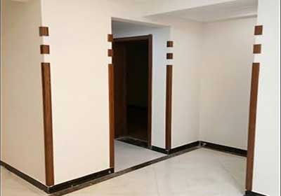 Decorative wood-effect PVC corner guards installed to match skirting and frames in a home interior