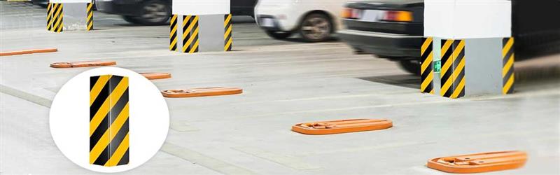 Bright yellow rubber corner guards in a busy commercial environment preventing accidents