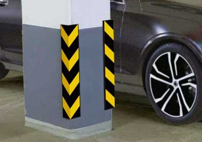 Rubber corner guard installed on warehouse wall protecting from forklift and trolley impacts