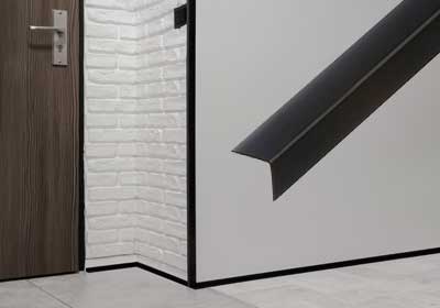 DIY installation of PVC corner trim on a wall for clean, straight corners