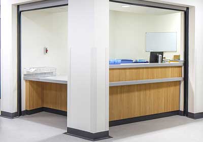 PVC corner guard protecting a wall corner from damage in a commercial setting