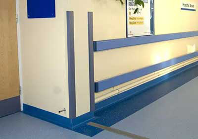 Unequal corner protectors installed on walls showing protection against damage and wear